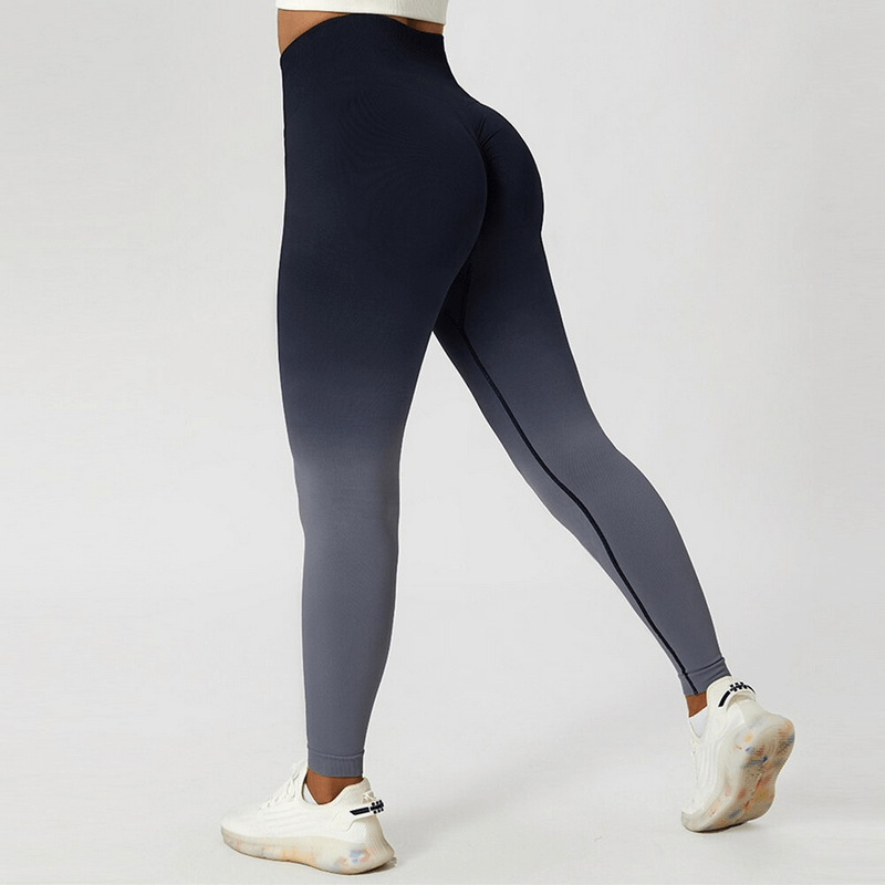 Women's gradient seamless elastic high waist leggings in navy and grey, perfect for yoga and fitness, shown from behind with white sneakers.